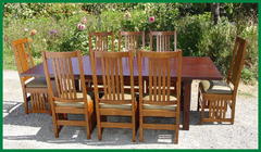 Set of eight chairs around large table without leaves installed.